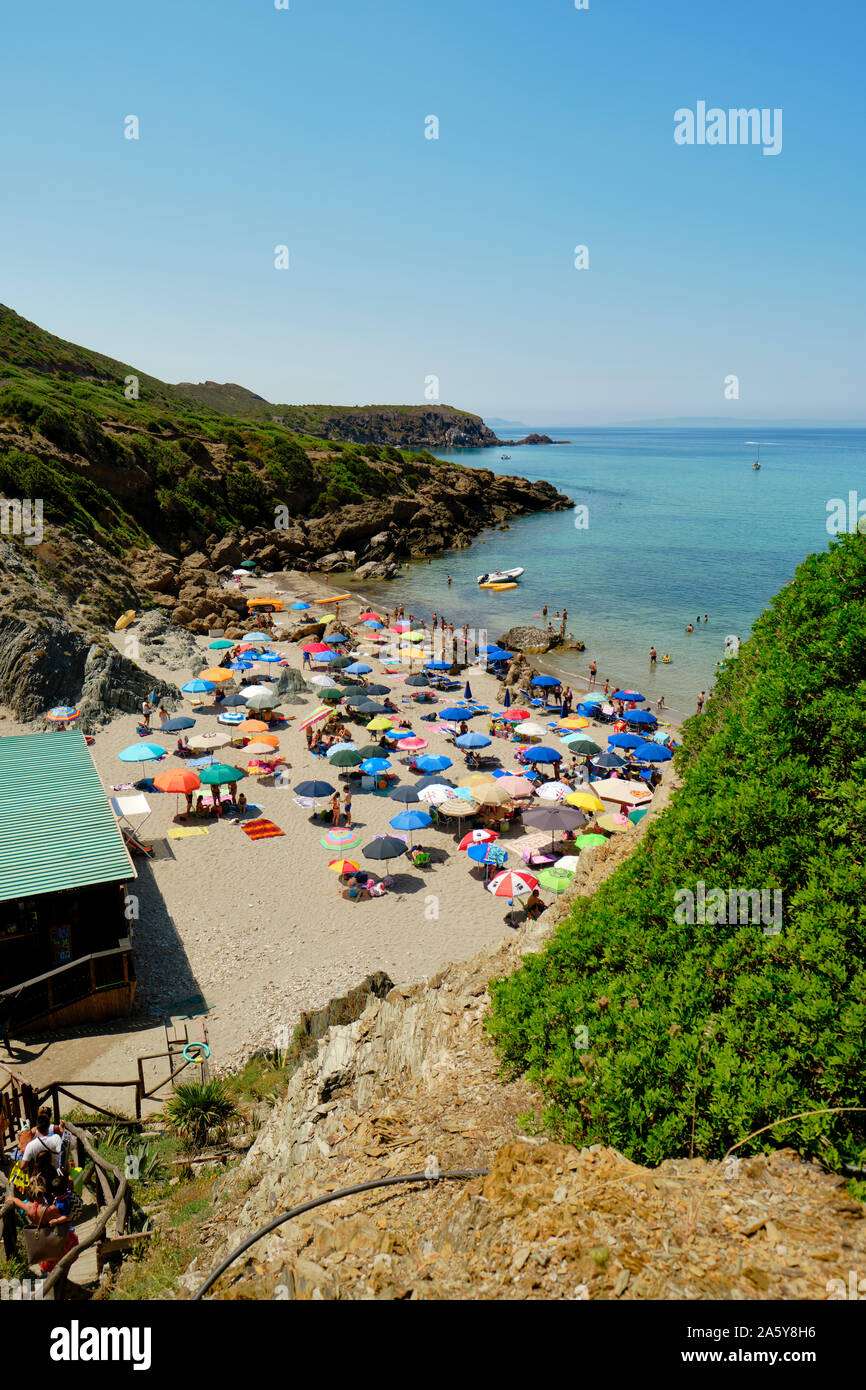 Die beliebten weißen Sand touristische Strand Spiaggia di Masua/Masua Strand mit bunten Strand Sonnenschirme auf der Iglesiente Küste Sardinien Italien Stockfoto