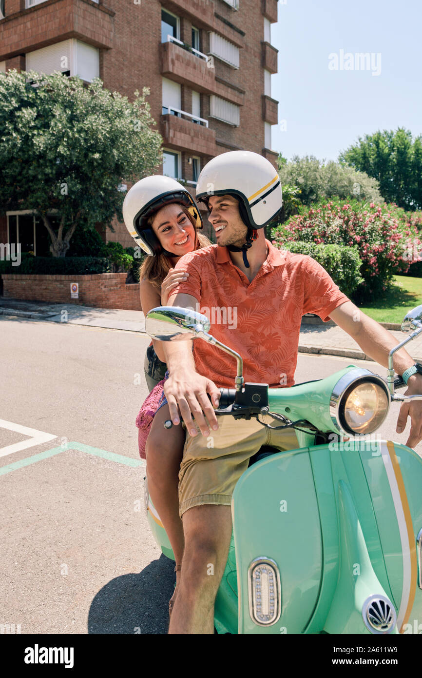 Junges Paar auf einem Oldtimer Motorroller Stockfoto