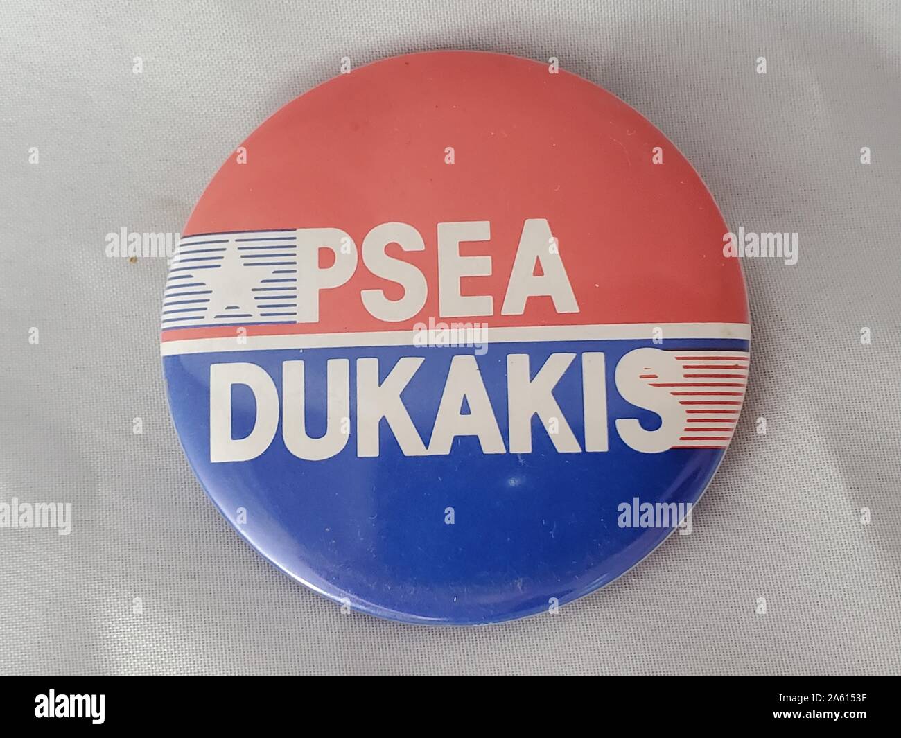 Rote, weiße und blaue Rückstecktaste oder -Abzeichen mit einem Stern, Streifen und dem Text "PSEA/Dukakis", der von der Pennsylvania State Education Association (PSEA) für die Präsidentschaftskampagne Michael Dukakis, Vereinigte Staaten von Amerika, 1988 herausgegeben wurde. () Stockfoto