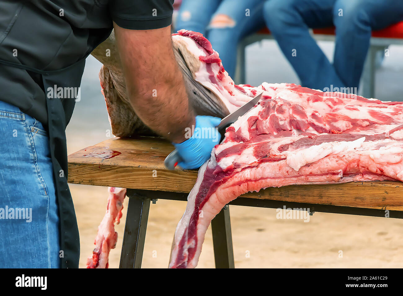 Metzger in Schlachtung und traditionelle Herstellung der iberischen Schwein und extrahieren Sie verschiedene Teile der Iberischen Schwein 2019 iberischer Schinken Messe von einem Stockfoto