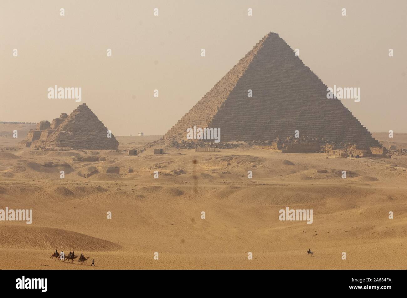 Menkaure Pyramide Komplex, an einem sonnigen Tag, mit Menschen reiten Kamele und ein Pferd, auf Sanddünen im Vordergrund, Giza, Ägypten, 7. Januar 2008. Vom Homewood Sammlung Fotografie. () Stockfoto