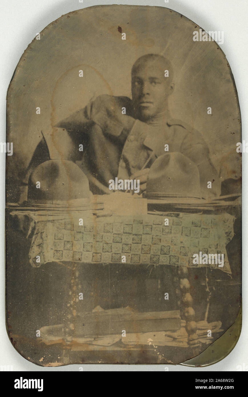 Weltkrieg Soldat, Brustbild, Sitz, Vorderseite, mit zwei Hüte auf Tisch Stockfoto