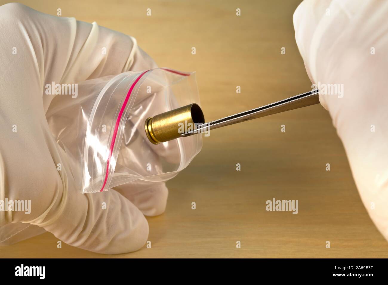 Crime Scene Investigation CSI forensische Beweise sammeln bullet Gehäuse mit einer Pinzette in Beweis Tasche - Polizei, Beweise oder forensischen Untersuchung Stockfoto