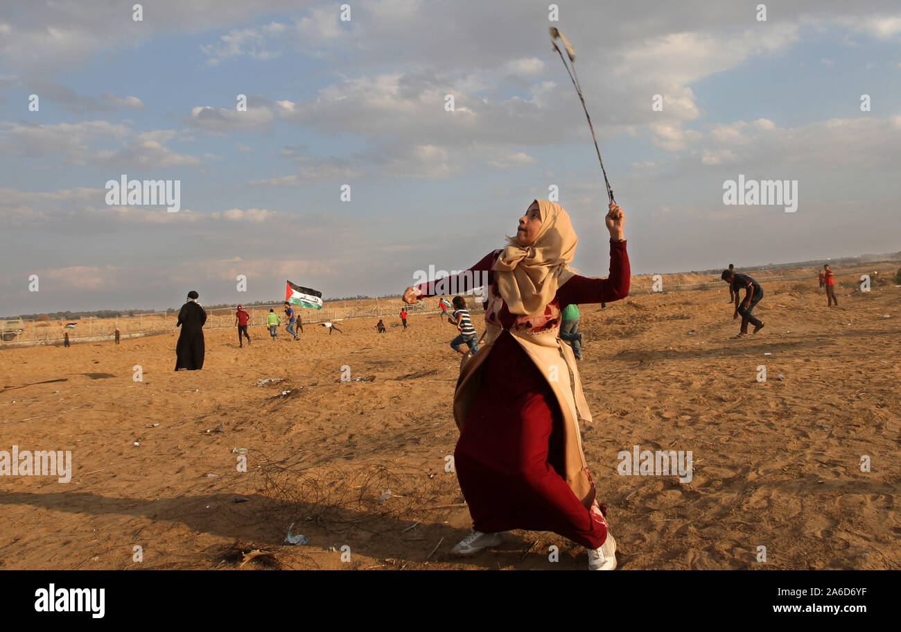 Khan Younis, in Gaza. 25 Okt, 2019. Eine palästinensische Frau Demonstrant verwendet eine Schleuder Steine während der Auseinandersetzungen mit der israelischen Streitkräfte zu schleudern nach einer Demonstration an der Grenze zu Israel östlich von Khan Yunis im südlichen Gazastreifen am Freitag am 25. Oktober 2019. 77 Palästinenser verletzt, durch die israelische Armee. Eine medizinische Quelle sagte. Foto von Ismael Mohamad/UPI. Quelle: UPI/Alamy leben Nachrichten Stockfoto