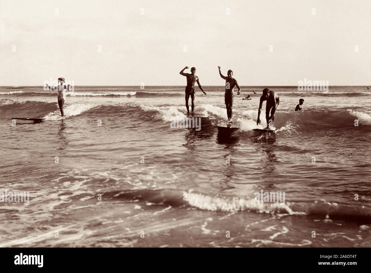 Vintage surfen Foto vom Waikiki Beach in Honolulu, Hawaii der Surfer auf Holz surfboards Teilen eine Welle. Stockfoto
