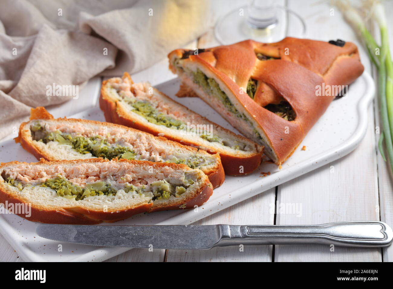 In Scheiben geschnittenen Lachs und Broccoli Torte auf einem rustikalen Tisch Stockfoto