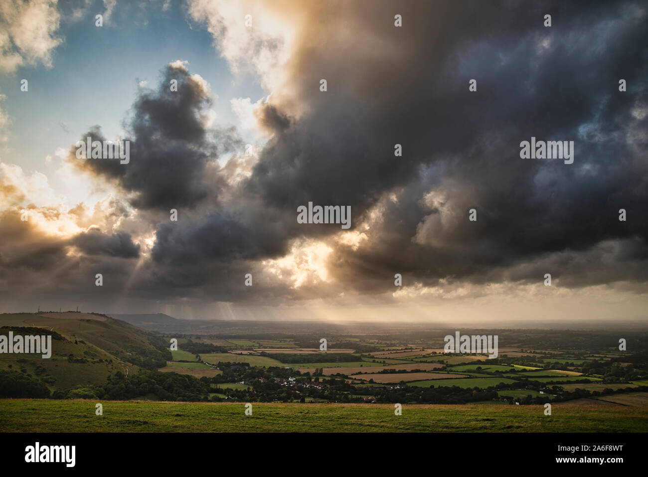 Schönen Sommer Landschaft Bild der Böschung mit dramatischen Sturm, Wolken und Sonne strahlen Streaming down Stockfoto