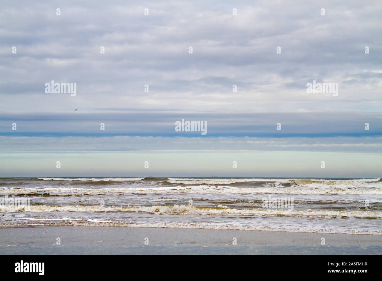 Horizontale Linien von Strand, Meer, Wellen, Wolken und blauer Himmel Stockfoto