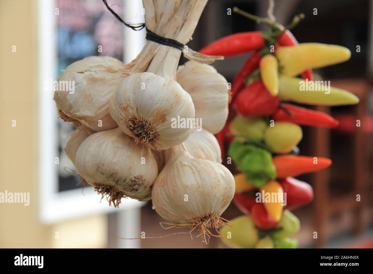 Ein Knoblauch Geflecht und Peperonis auf einem Markt Stockfoto