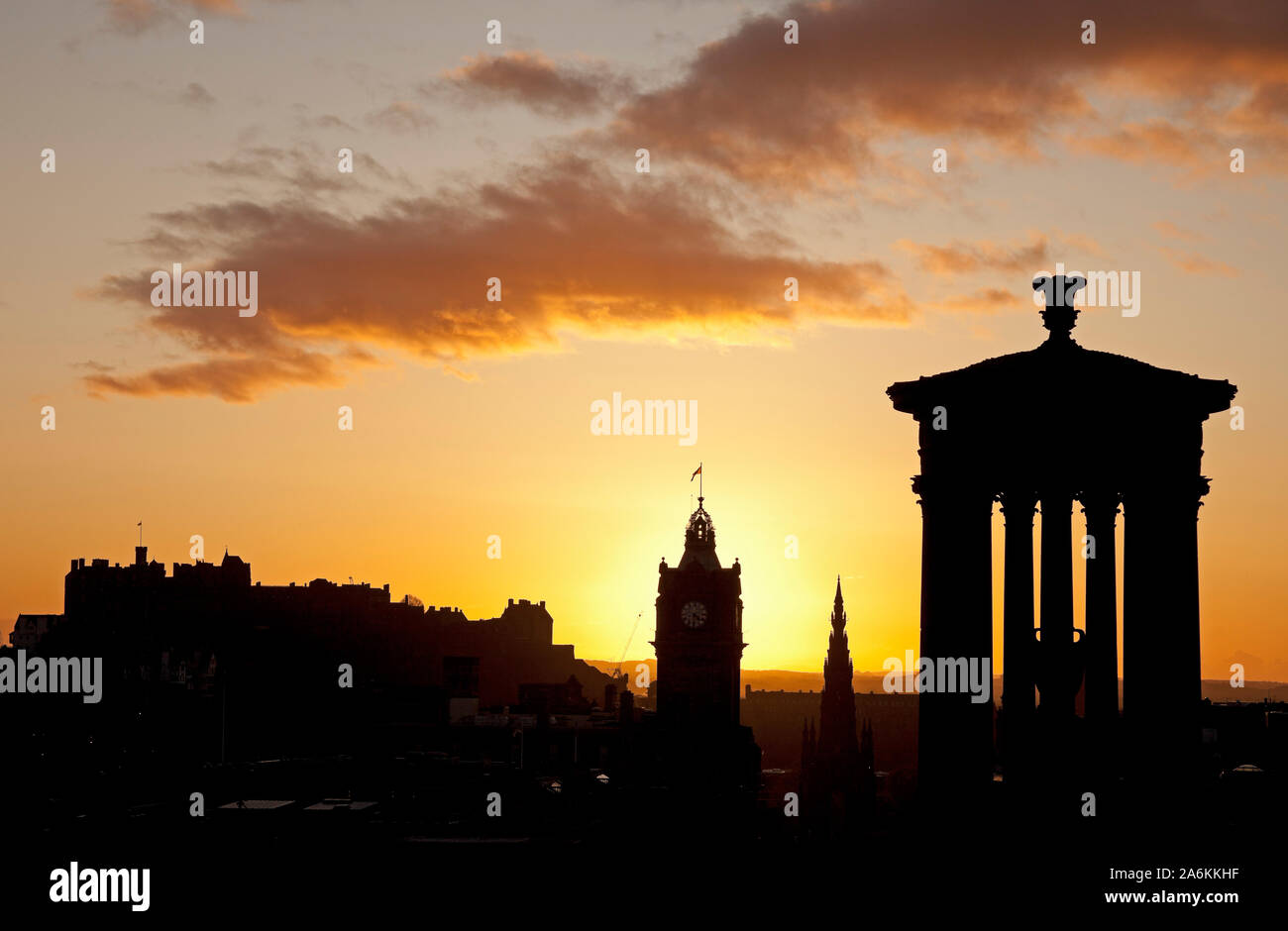 Calton Hill, Edinburgh, Großbritannien. 27. Oktober 2019. UK Wetter. Farbenfroher Sonnenuntergang über der Innenstadt eine Silhouette von Dugald Stewart Monument und schloss mit Balmoral Hotel Clock Tower, einem kühlen 10 Grad. Stockfoto