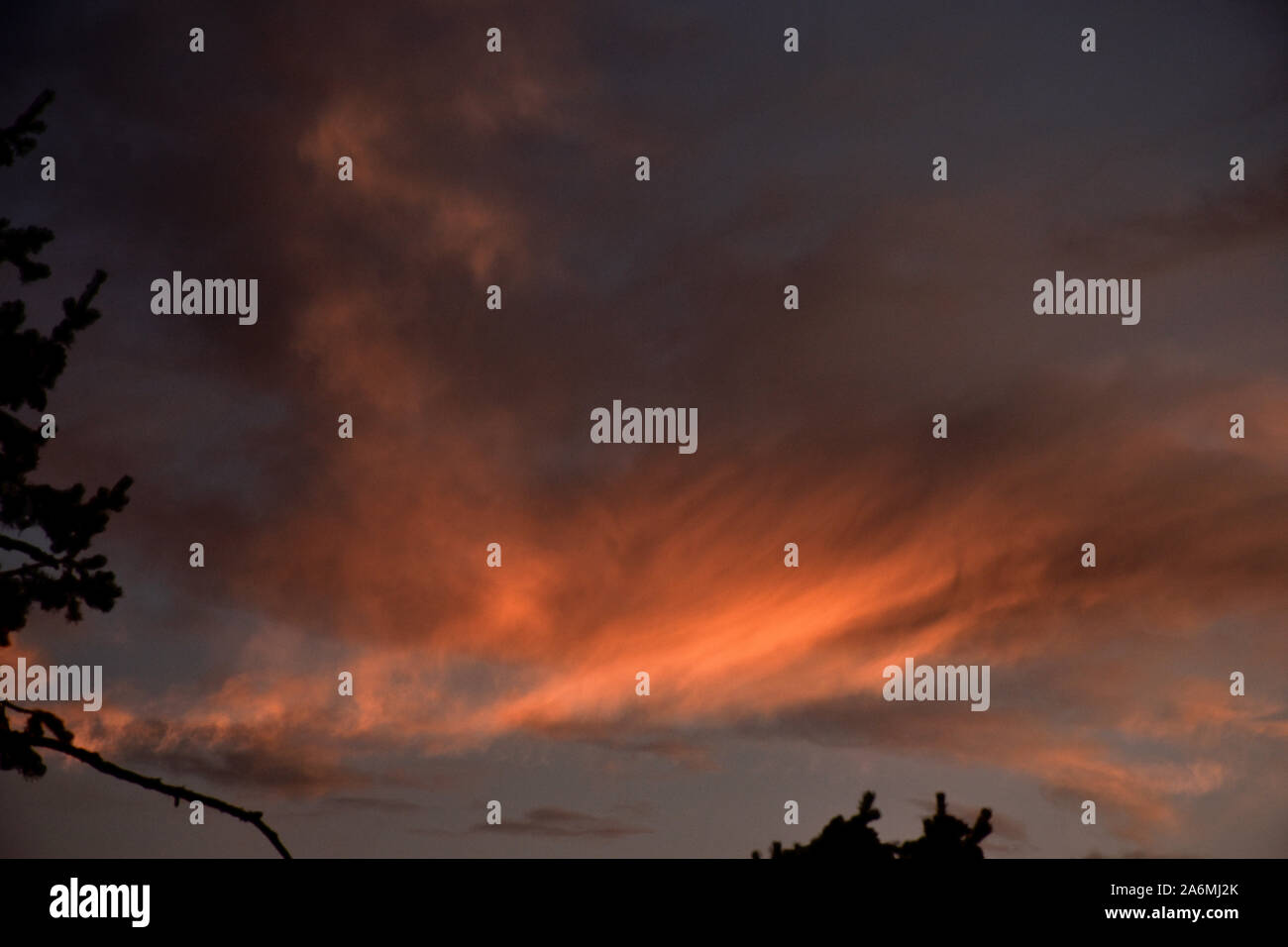 Weiche Wolken rollen über einen Himmel bei spätem Sonnenuntergang. Stockfoto