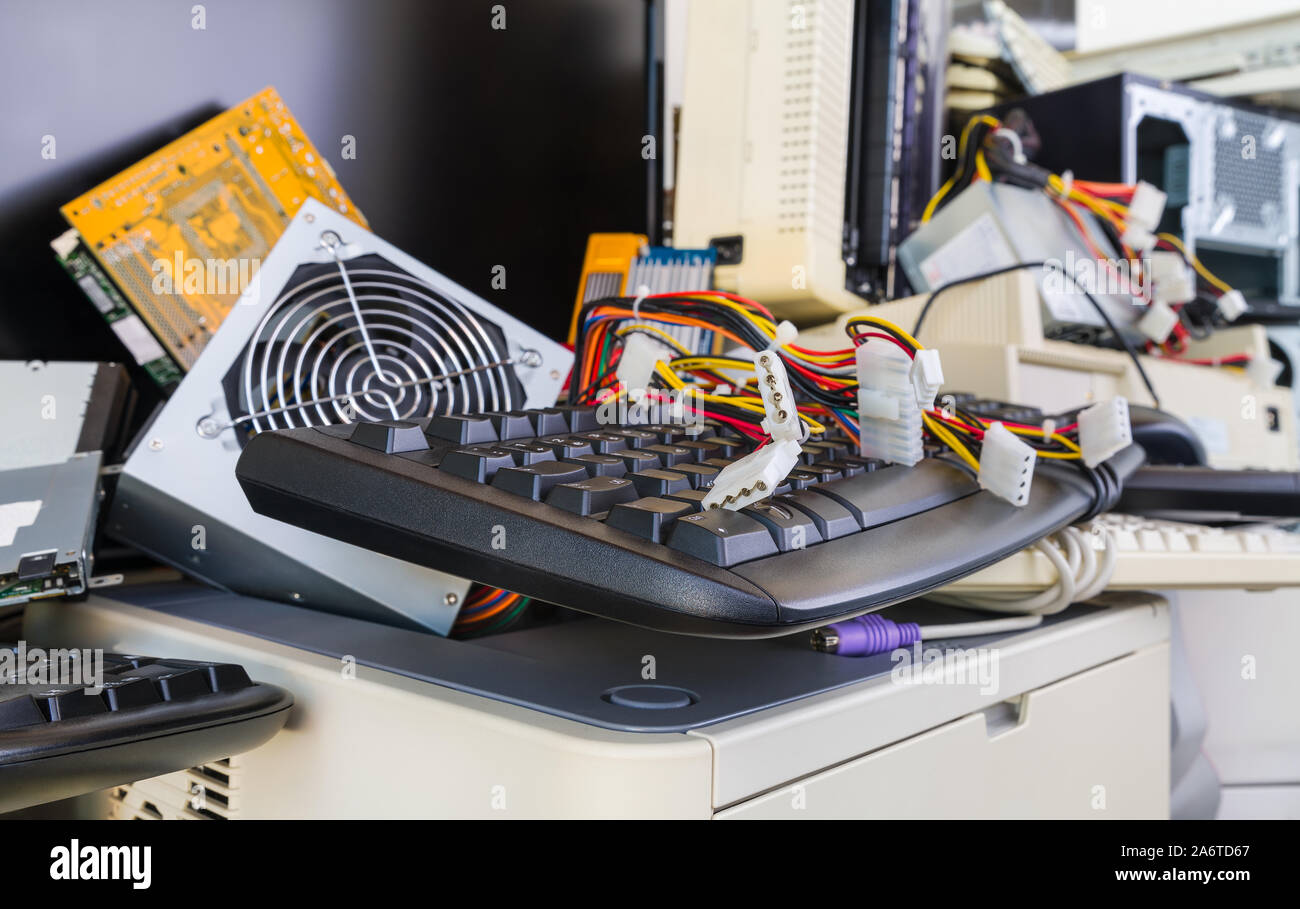 Computer hardware Komponenten auf e-Halde. Verworfen oder veraltete Ersatzteile und Zubehör. Tastaturen, Drucker, Lüfter, Farbige Kabel, Stecker. Stockfoto