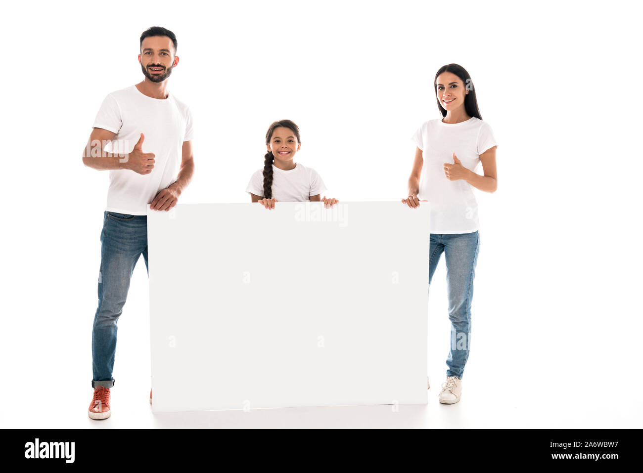 Glückliche Eltern zeigen Daumen hoch beim Stehen in der Nähe von Kid und ein leeres Plakat isoliert auf weißem Stockfoto