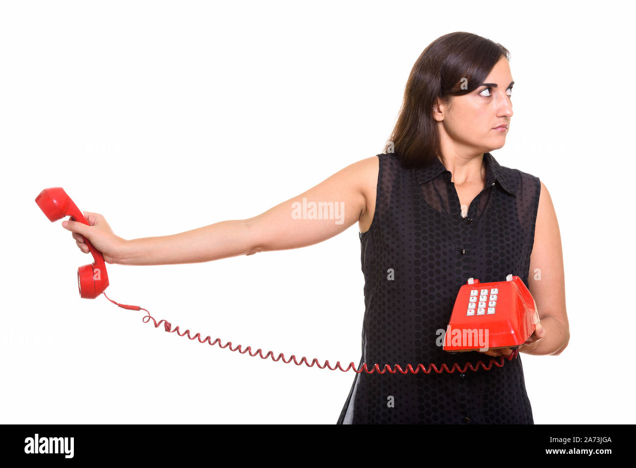 Porträt der jungen schönen Frau mit alten Telefon Stockfoto