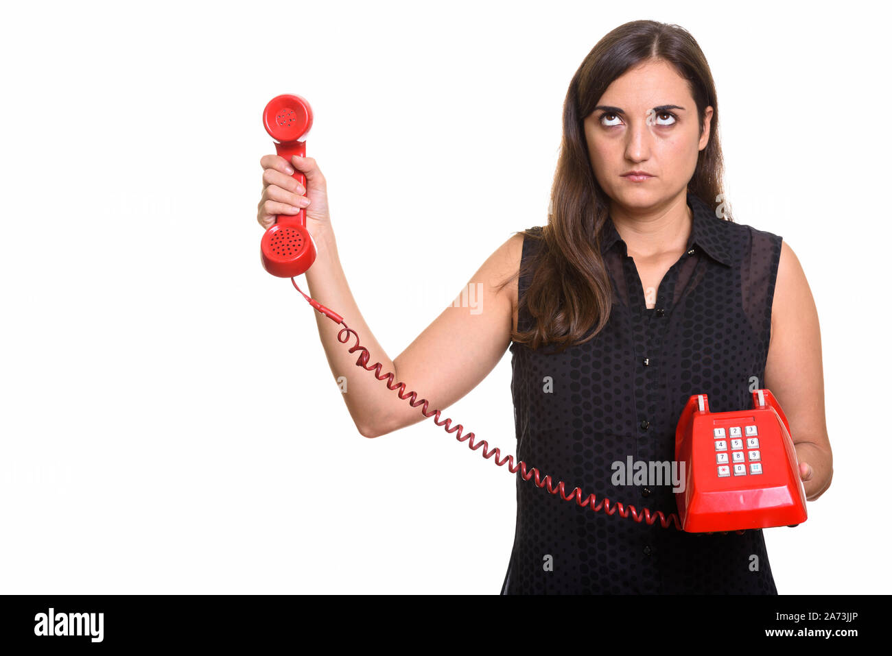 Porträt der jungen schönen Frau mit alten Telefon Stockfoto