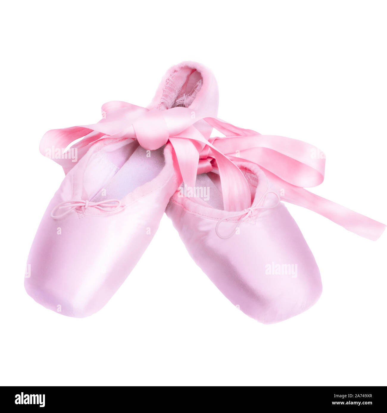 Pointe Shoes Ballet dance Schuhe mit einem Bogen der Bänder wunderschön auf einem dunklen Hintergrund gefaltet Stockfoto