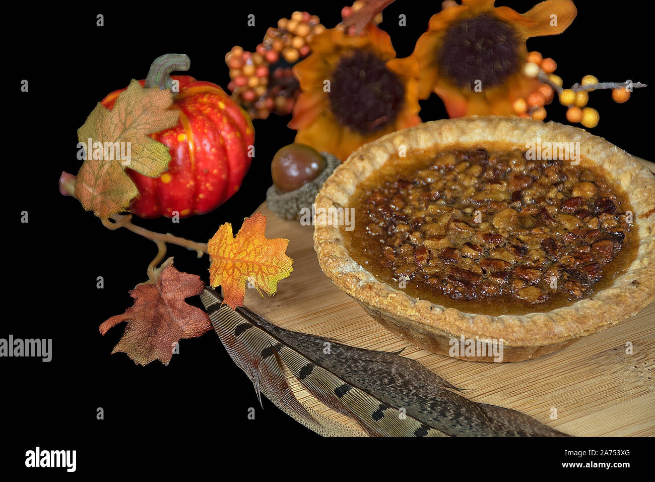 Pecan Pie mit Fasan mit Feder und Blätter im Herbst auf Holz Stockfoto