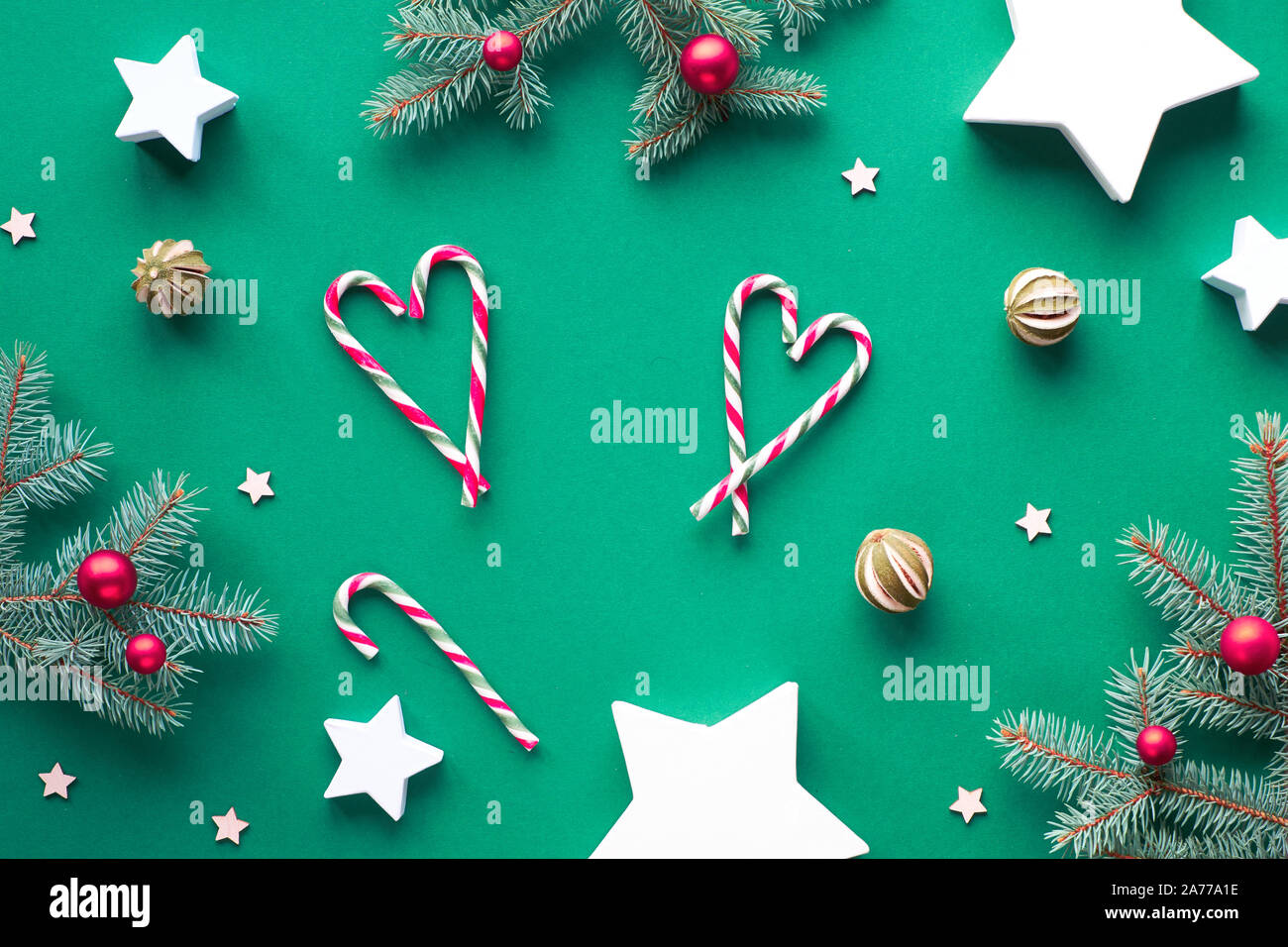 Kreative Weihnachten mit Tanne Zweige legen, Zuckerstangen angeordnet, wie Herzen, rotem Glas Kugeln und trockenen Kalk Früchte. Papier geschenkboxen als Stars geprägt. Z Stockfoto