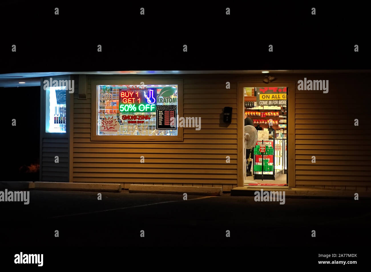 Storrs, CT USA. 22.September 2019. Head Shop nachts mit Kunden, helles Neon Zeichen und Fenster anzeigen. Stockfoto