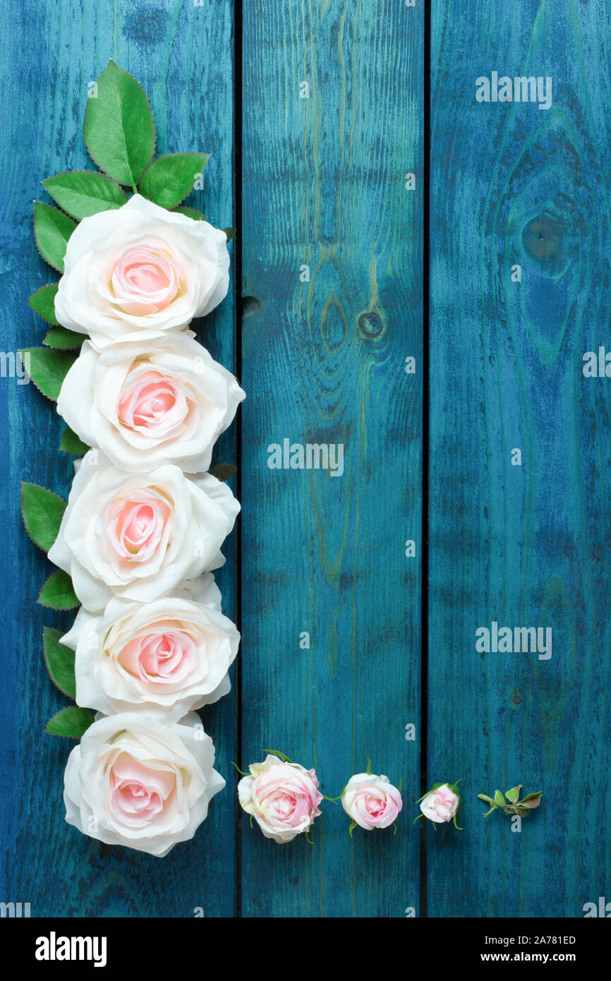 Hochzeit Grenze mit hellrosa rosa Blüten auf blauem Hintergrund Holz Stockfoto