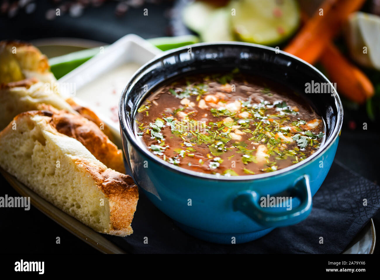 Traditionelle türkische Suppe aus Rumänien mit frischem Gemüse, Wischcreme, Gewürzen und hausgemachtem Brot Stockfoto