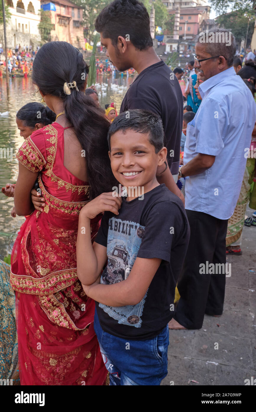 Ein Junge mit seiner Familie Familie Banganga Tank, Walkeshwar, Mumbai, Indien, Teilnahme an Festival Chhath Puja, das ehrt Gott der Sonne Suryadev Stockfoto