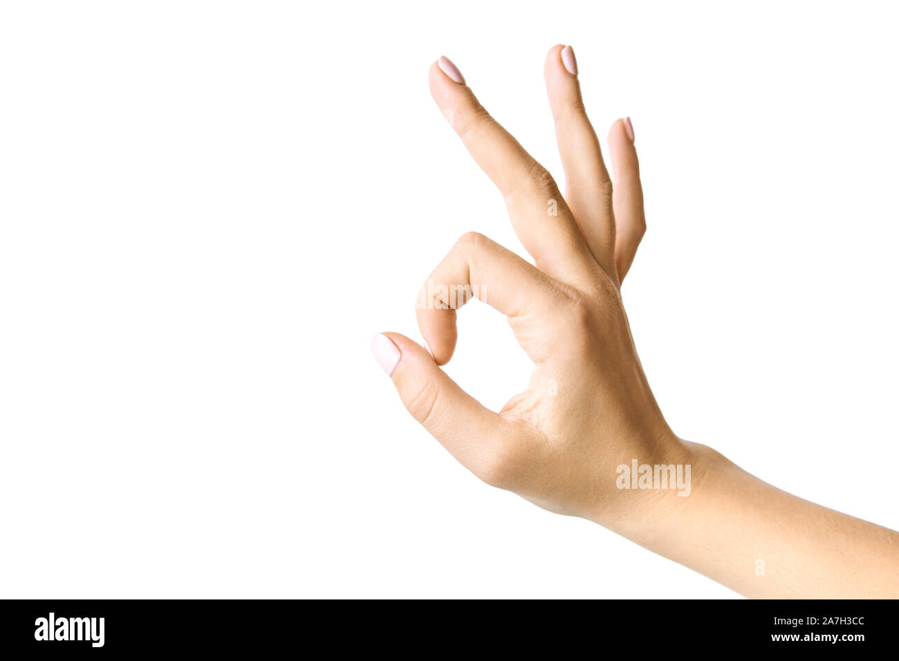 Schöne weibliche Hand gestikulierend. Okay Symbol. Auf weissem Hintergrund. Stockfoto