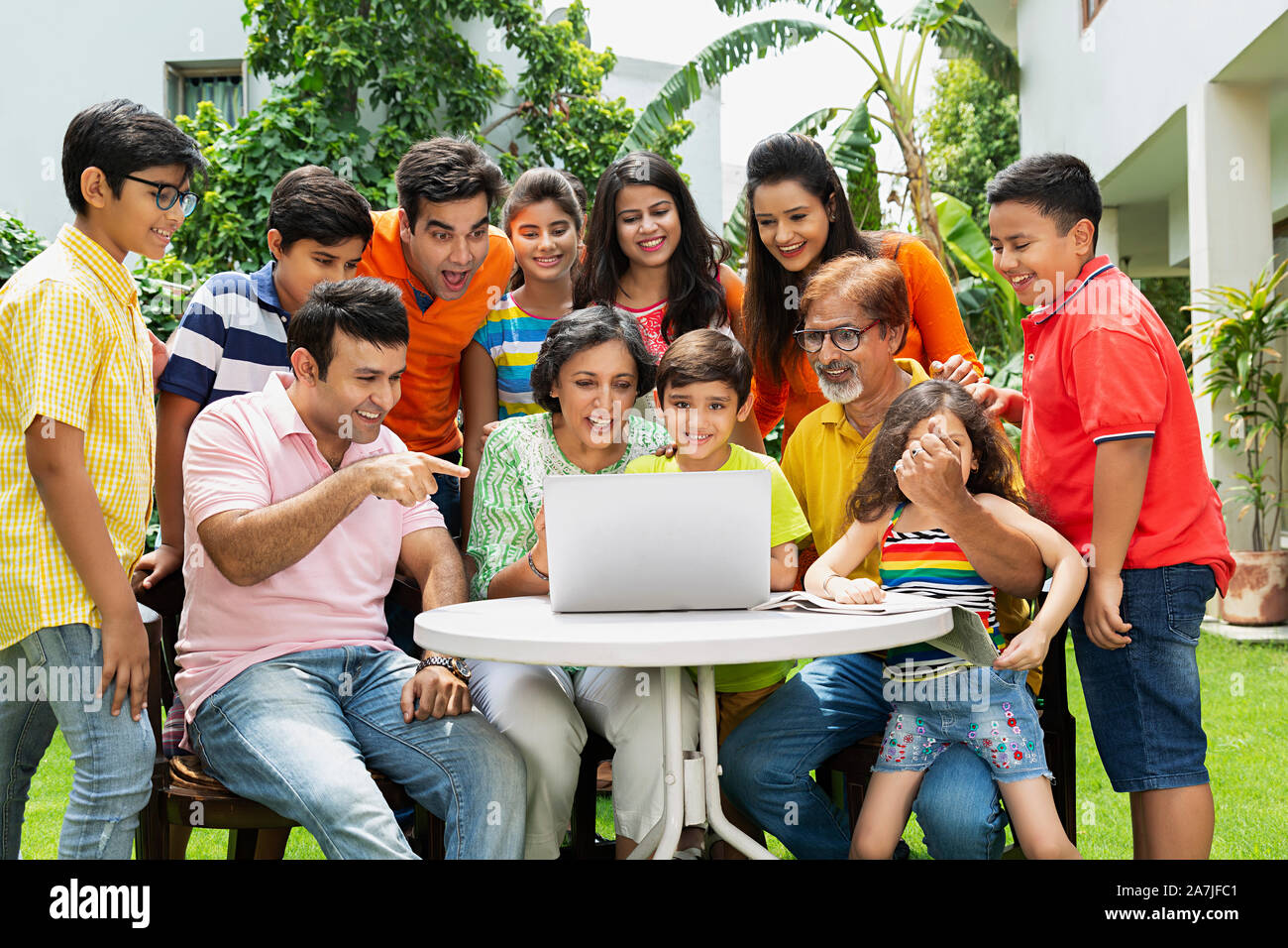 Gruppe - von glücklichen großen Familien, - bei Laptop- und der Zeigefinger in-Home Garten Stockfoto