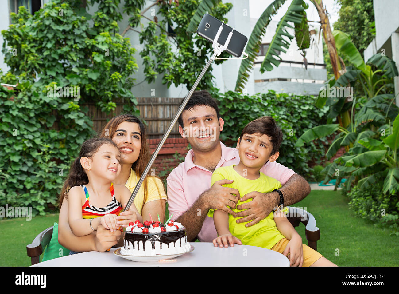 Glückliche Familie selfie Foto vom Smartphone mit selfie-Stick während feiert Geburtstag in-Hof - Ihr Zuhause Stockfoto