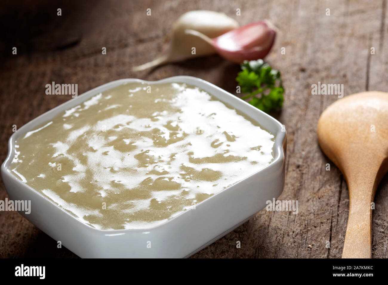 Frische homade Knoblauch Sauce mit einem kleinen Löffel aus Holz Stockfoto