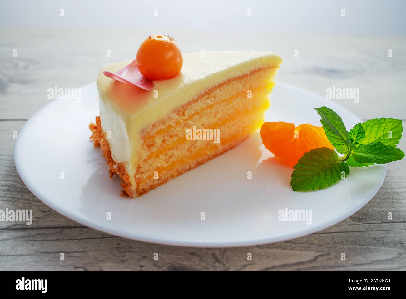 Schokoladenkuchen mit physalis Früchte, Sahne, Nüsse, Mousse und Minze auf weißem Hintergrund Stockfoto