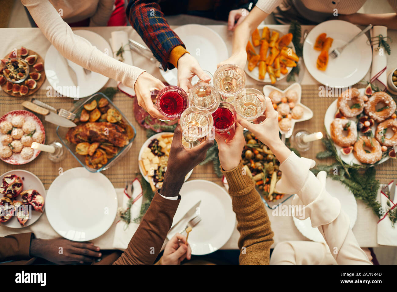 Ansicht von oben Hintergrund der Menschen erhöhen Gläser über festliche Abendessen, während wir Weihnachten feiern mit Freunden und Familie, kopieren Raum Stockfoto