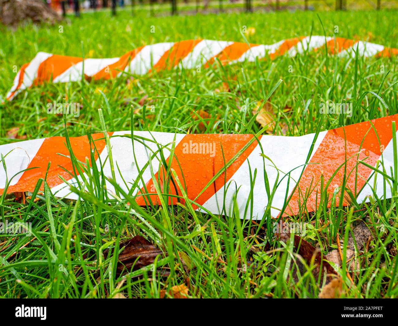 Grenze gestreift Ribbon auf grünem Gras. Hintergrund. Für Text platzieren. Stockfoto