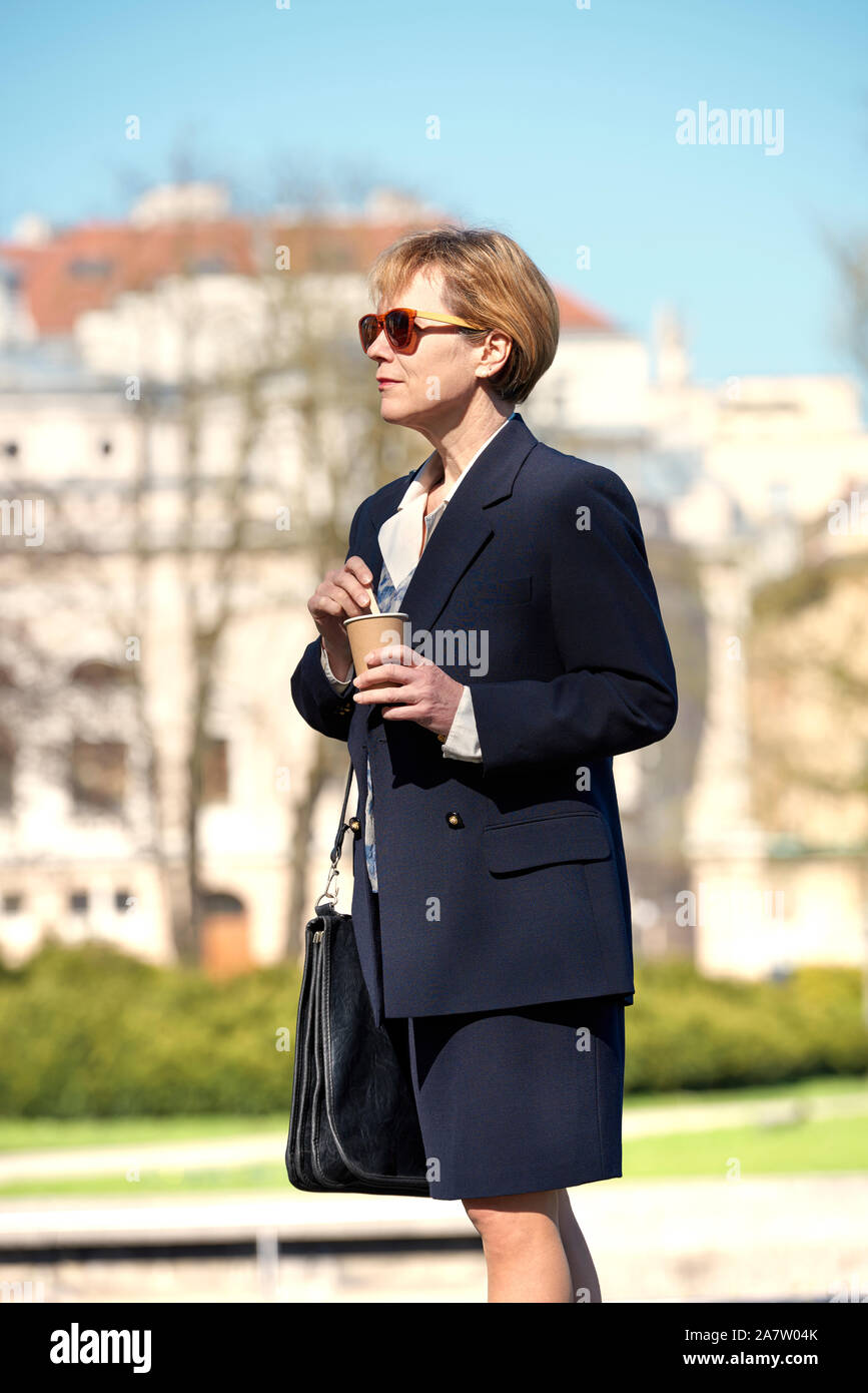 Ein elegantes Business Frau auf der Straße genießen Sie Kaffee aus dem pappbecher Stockfoto