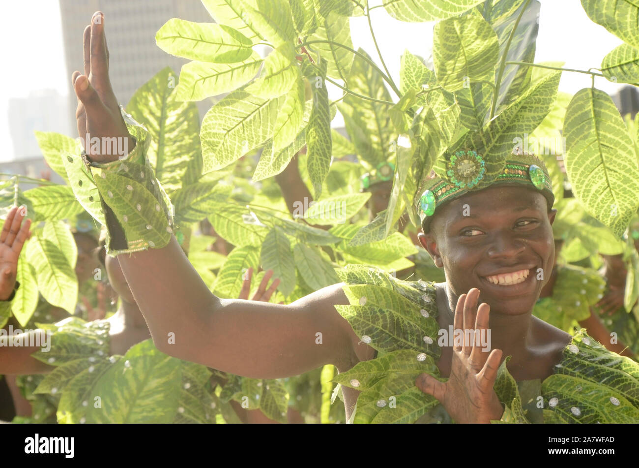 Ein junger Mann in seinem grünen Blatt Kostüm drückt seine Freude auf dem Lagos Karnevalsgelände aus. Stockfoto