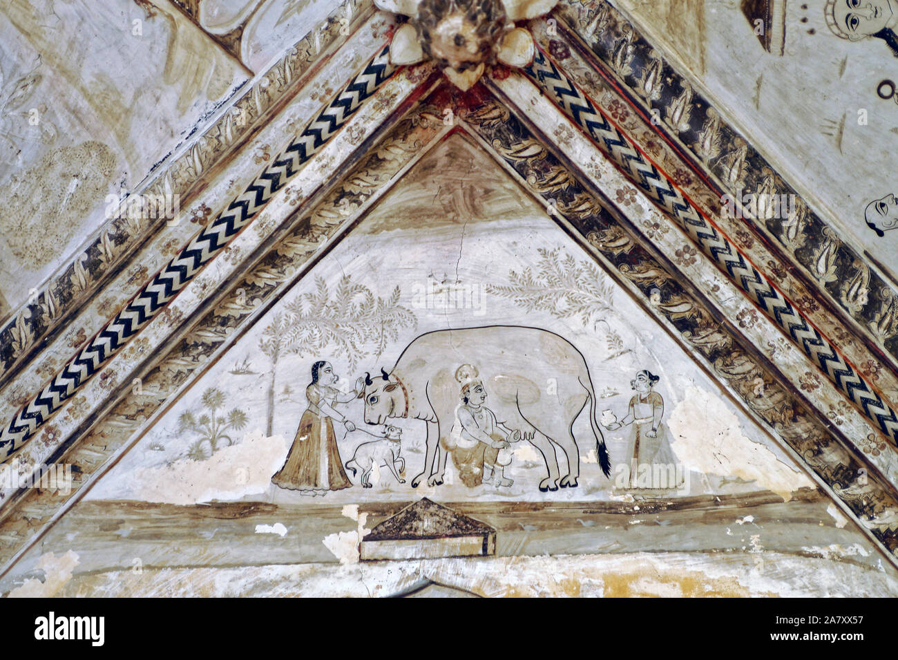 Malerei von Krishna das Melken einer Kuh von Hand Stockfoto