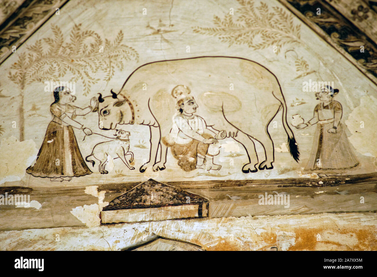 Malerei von Krishna das Melken einer Kuh von Hand Stockfoto