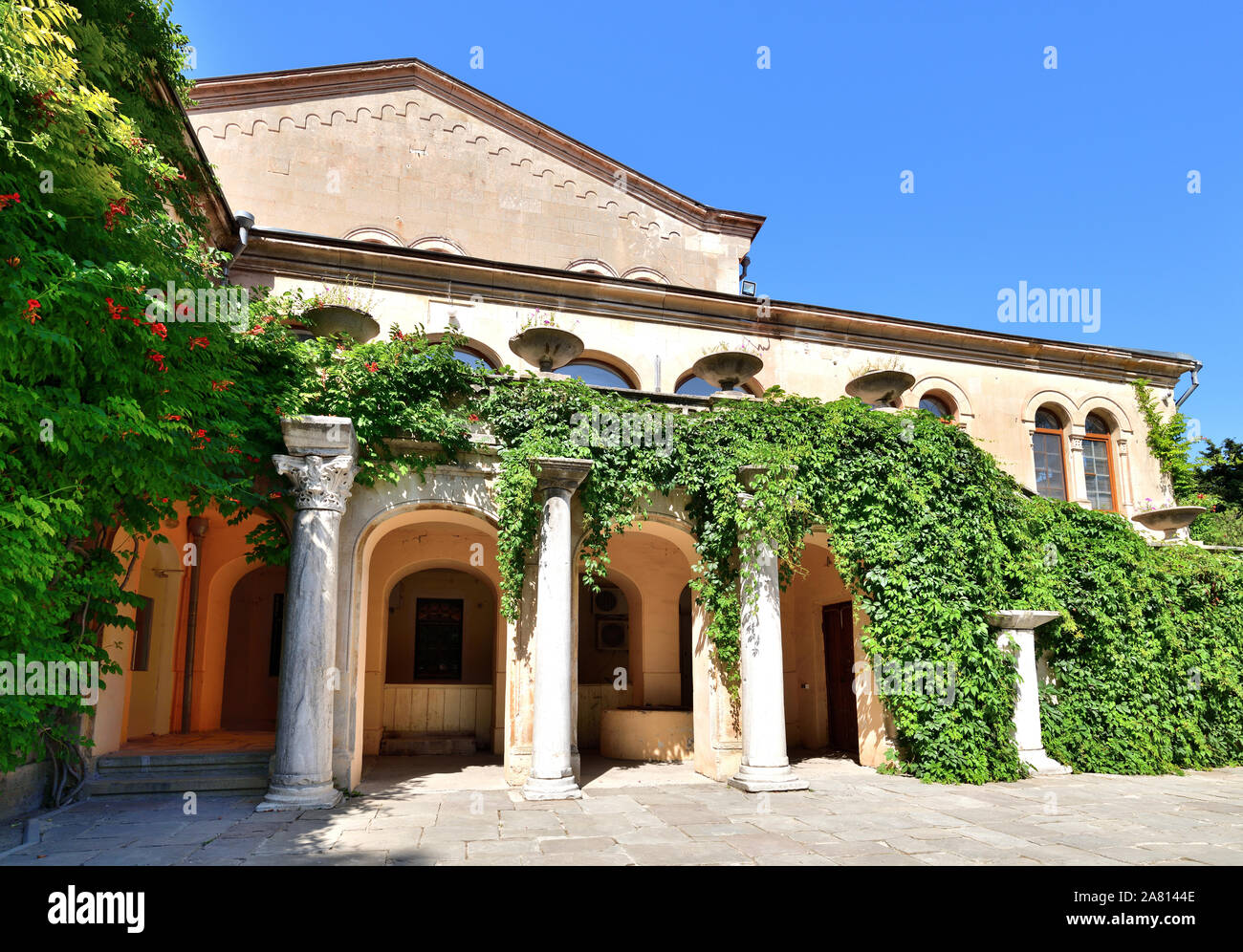 Ein antikes Gebäude mit Säulen mit Efeu Stockfoto