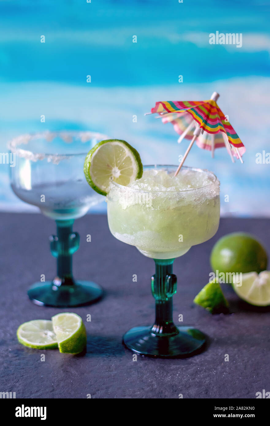 Kalt und eisig Frozen margarita Getränke mit Schichten aus Kalk und ein Regenschirm Stockfoto