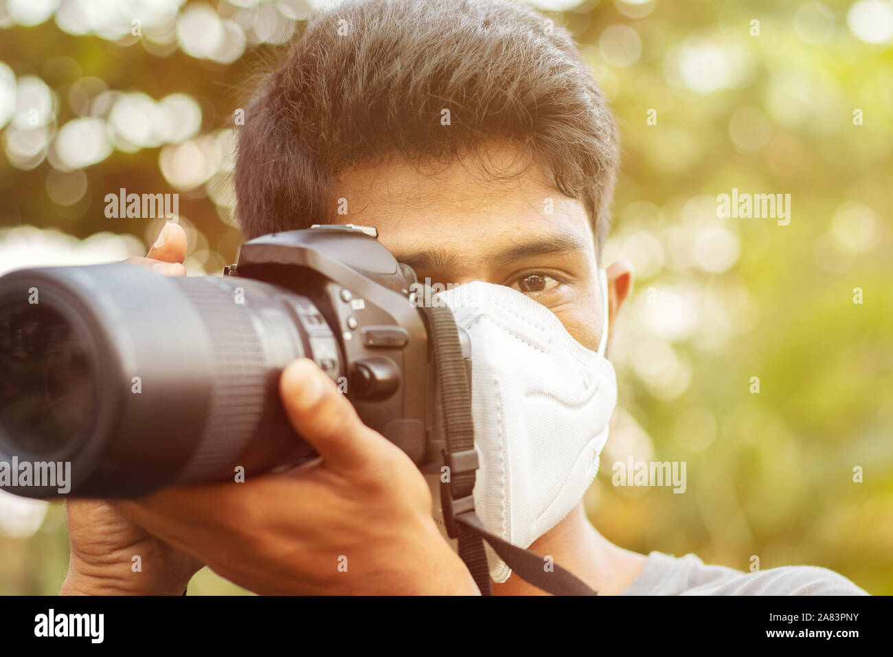 Junge Fotograf mit Umweltverschmutzung Maske - Begriff des Fotojournalismus und seine Gefahr. Stockfoto
