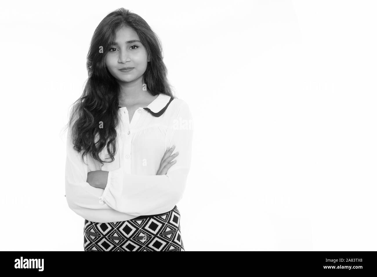 Studio shot der jungen schönen persischen Geschäftsfrau mit verschränkten Armen Stockfoto