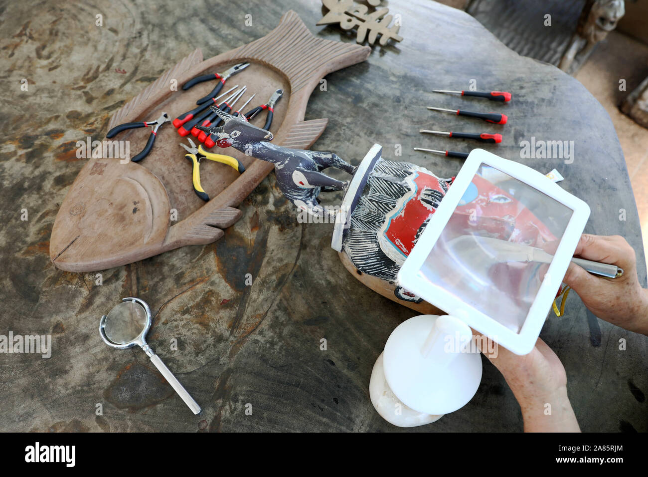 Lome, Togo. 29 Okt, 2019. Xie Yanshen Reparaturen eine ivorische Maske bei internationalen Museum des Golfs von Guinea in Lomé, der Hauptstadt von Togo, Okt. 29, 2019. Xie Yanshen, einer chinesischen Sammler, hat in 40 Länder in Afrika in den vergangenen 30 Jahren reiste und sammelte fast 10.000 Stück der afrikanischen Kunstwerken. Er gründete das Internationale Museum des Golfs von Guinea in Lomé, zieht eine große Zahl von Touristen afrikanische Kunst und Kultur jedes Jahr zu erleben. Credit: Wang Teng/Xinhua/Alamy leben Nachrichten Stockfoto