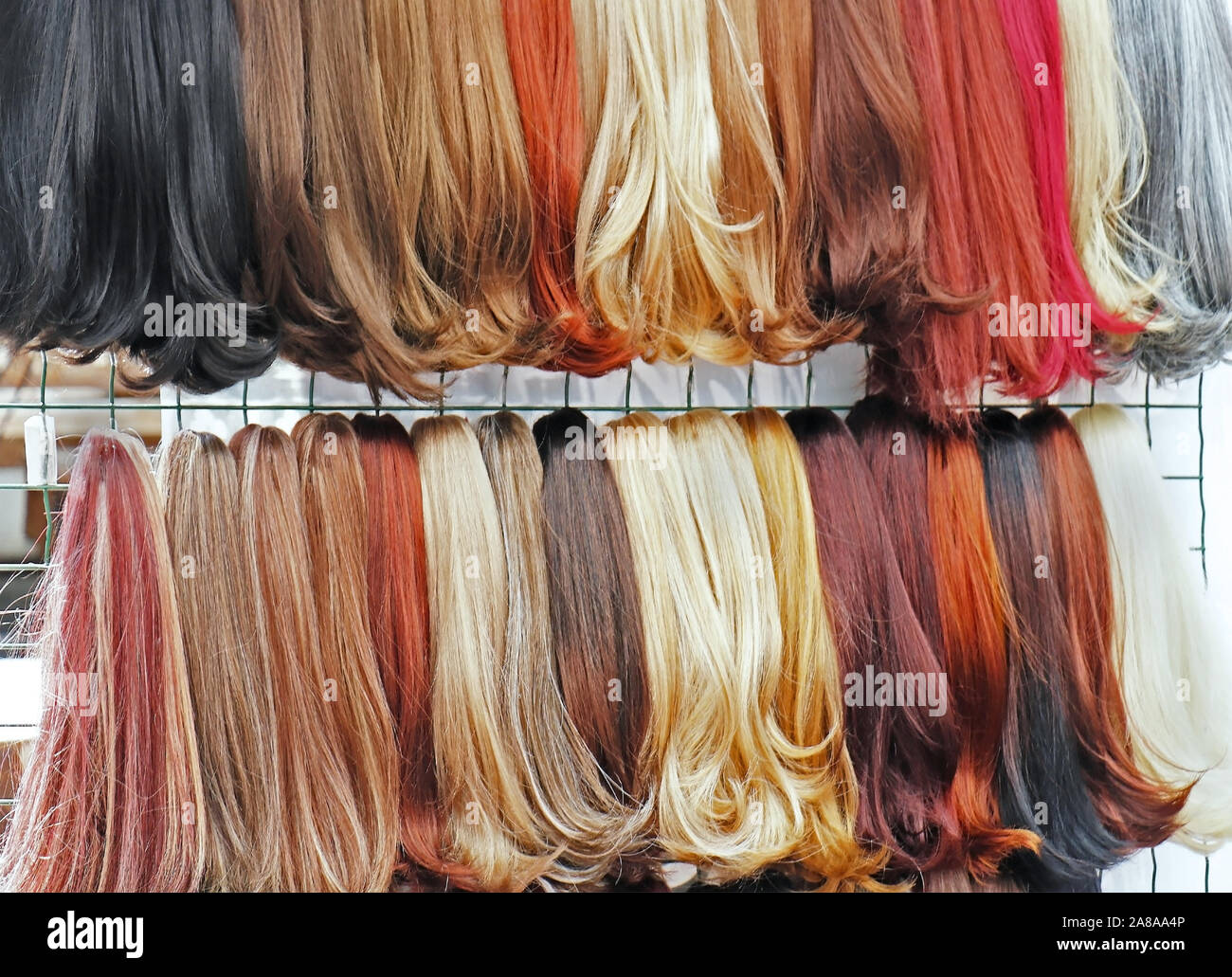 Glattes Haar synthetisches bunte Perücken auf dem Markt verkauft. Stockfoto