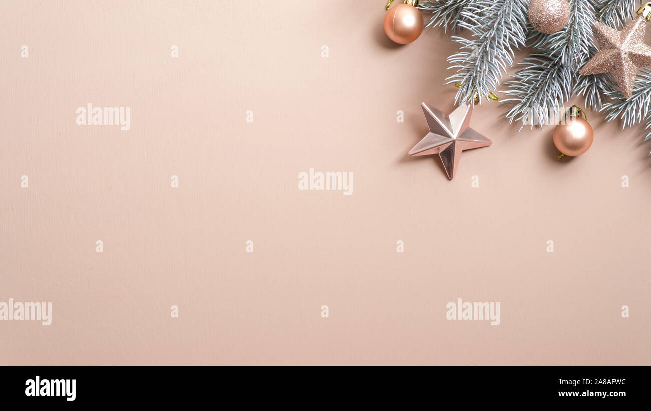 Christmas tree branch mit Creme farbigen Kugeln und Sterne auf Kupfer Hintergrund. Flach, Ansicht von oben, kopieren. Minimal Style Xmas Komposition. Weihnachten Stockfoto