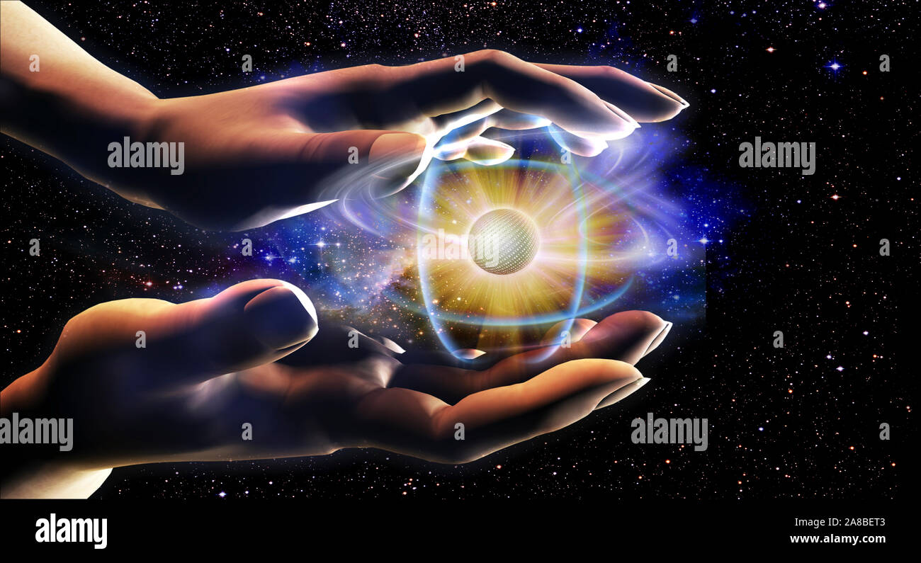 Person's Hände halten ein Atom Stockfoto