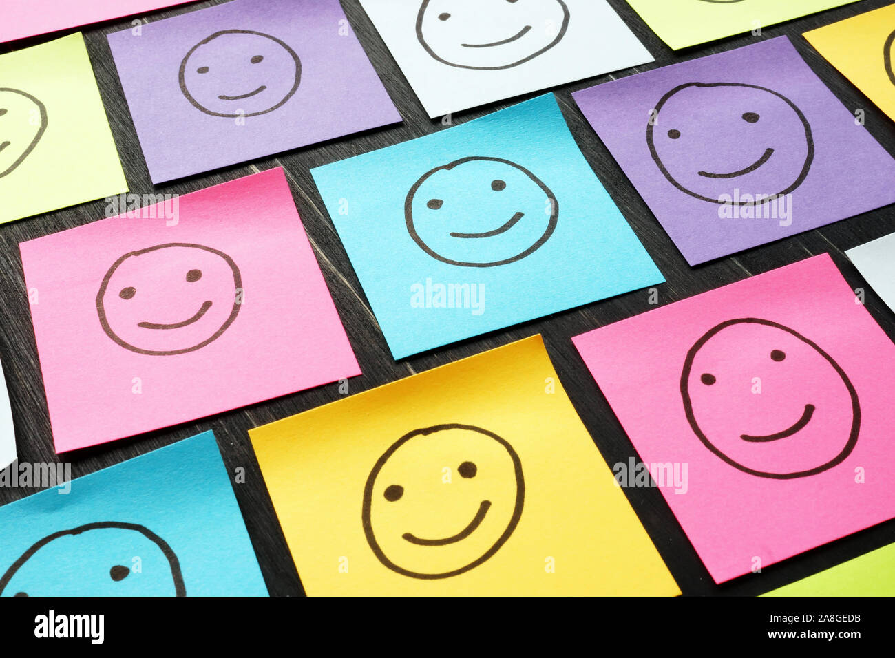 Lächelnd glückliche Gesichter auf Blättern gezeichnet. Kunden Erfahrung und Evaluation Konzept. Stockfoto