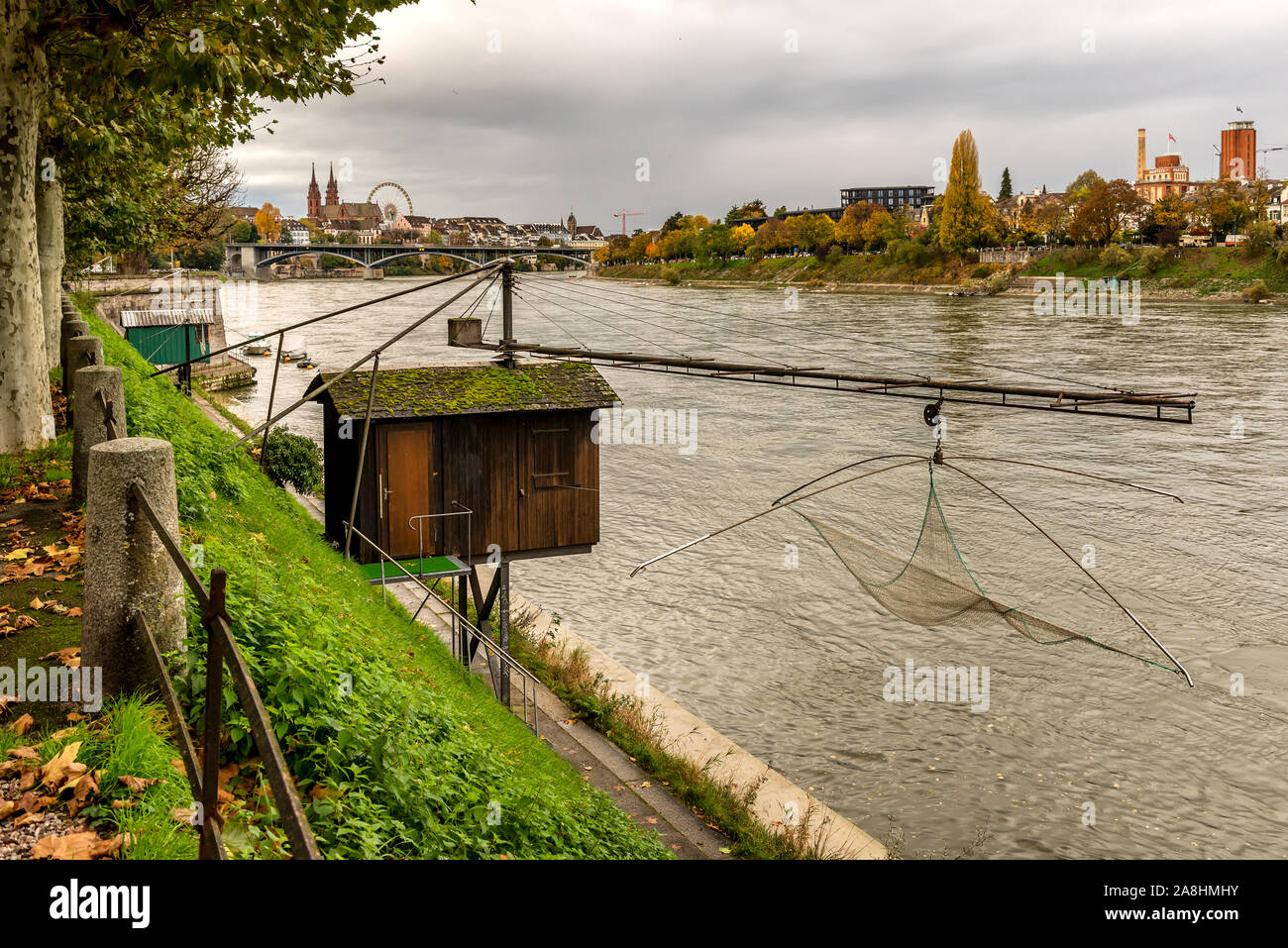Rhein und alte Fischerhütte in Basel, Schweiz und mit alten Stadtzentrum von Basel mit Munster Dom im Hintergrund Stockfoto