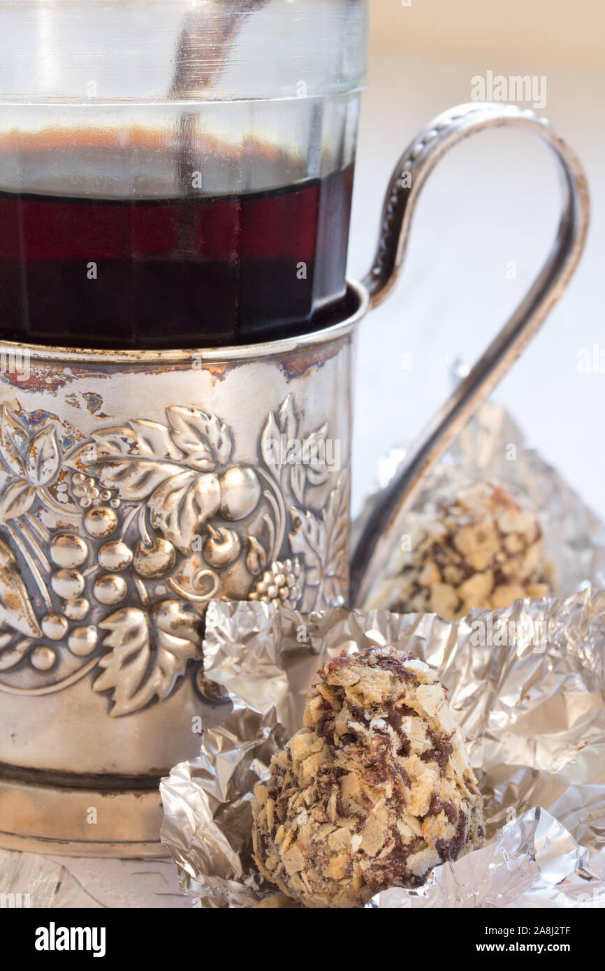 Bonbons in Schokolade und eine Tasse Kaffee das Alte - Halter Stockfoto