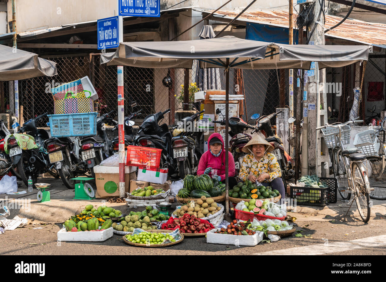 Nha Trang, Vietnam - 11. März 2019: Duong Huynh Thuc Khang Markt. 2 Frauen verkaufen frisch geerntete Obst in kleinen Mengen an der Ecke der Straße. Bunc Stockfoto