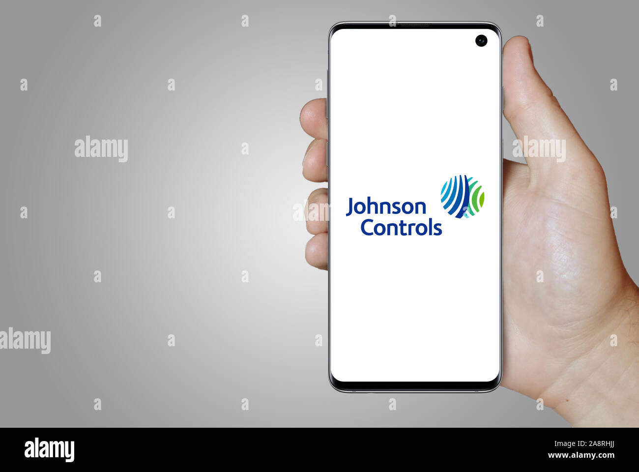 Logo der öffentlichen Unternehmen Johnson Controls International angezeigt auf einem Smartphone. Grauer Hintergrund. Credit: PIXDUCE Stockfoto